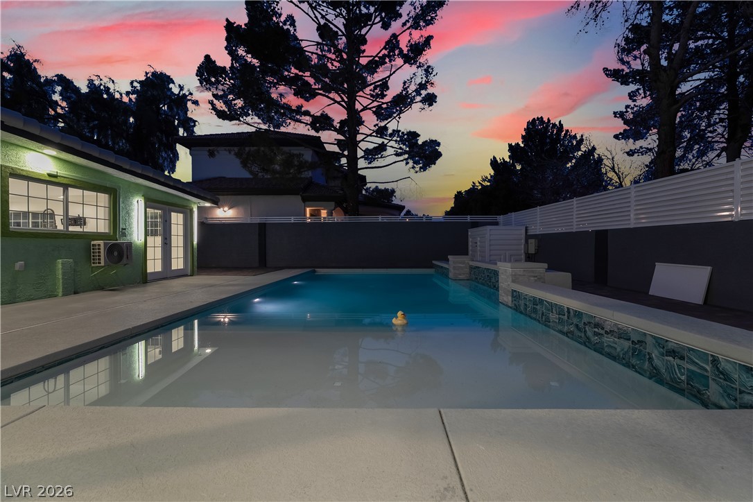 3160 East Viking Road Las Vegas, NV 89121 - Photo 91 of 99 View of pool with french doors, a fenced backyard, and patio surround