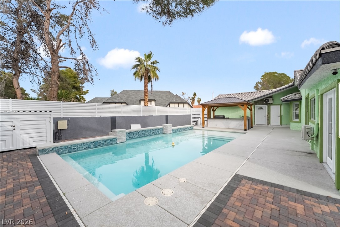 3160 East Viking Road Las Vegas, NV 89121 - Photo 93 of 99 View of pool featuring a gazebo, patio surround, a fenced backyard, and a hot tub