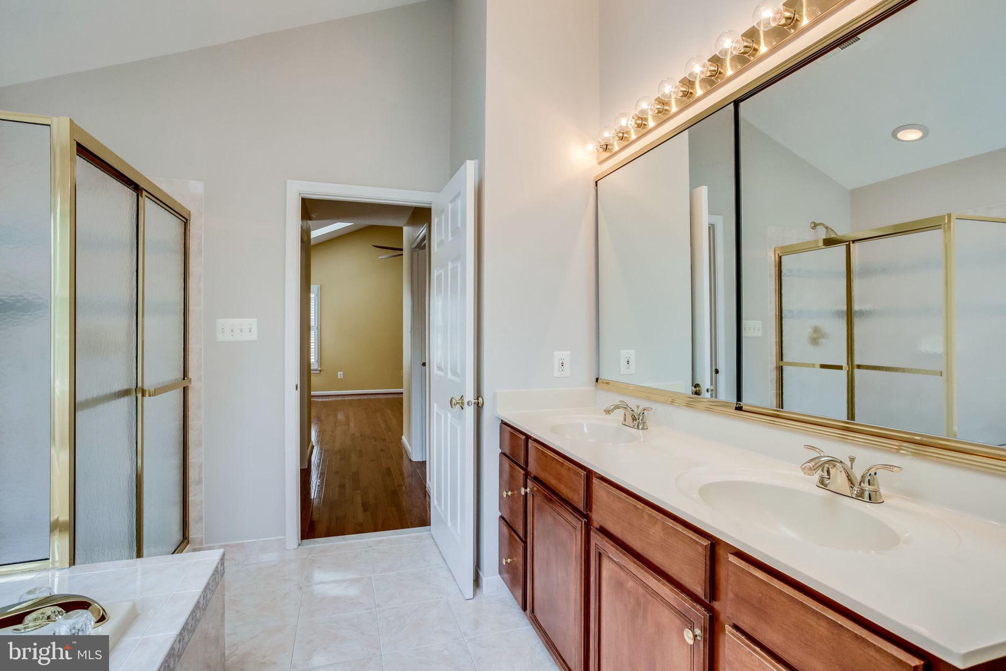 10851 Grovehampton Court Reston, VA 20194 - Photo 24 of 49 a bathroom with a double vanity sink mirror and double