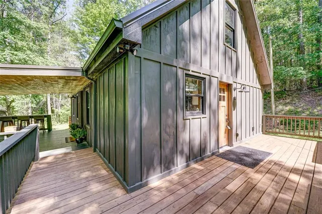 a bathroom with a sink and a large mirror next to a window
