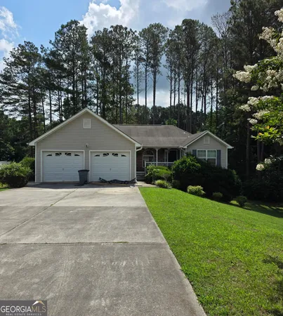 a front view of house with yard and green space