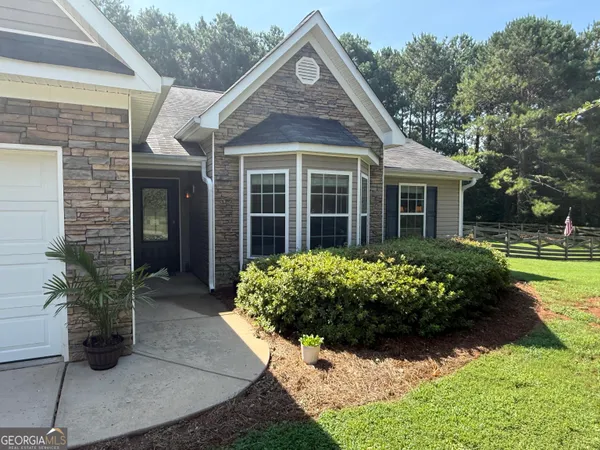 a front view of a house with garden