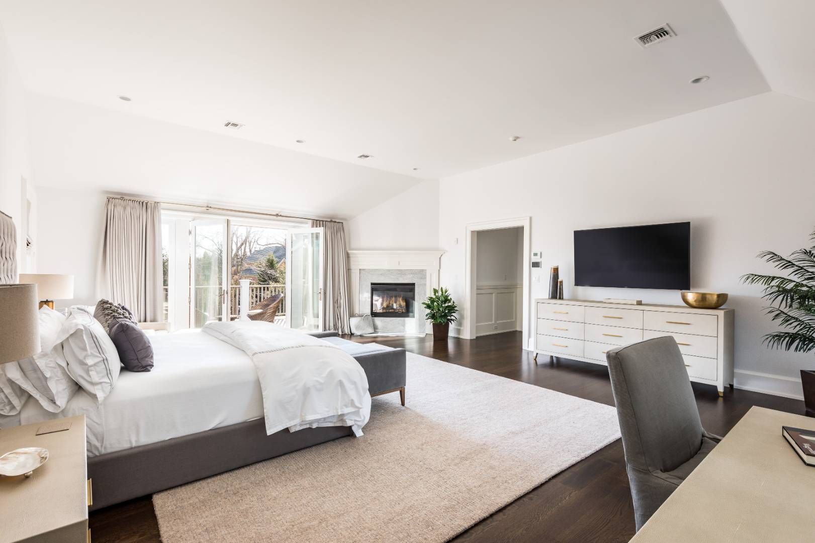 6 Shady Pth Bridgehampton, NY 11963 - Photo 14 of 20 a bedroom with a bed a flat screen tv and a couch