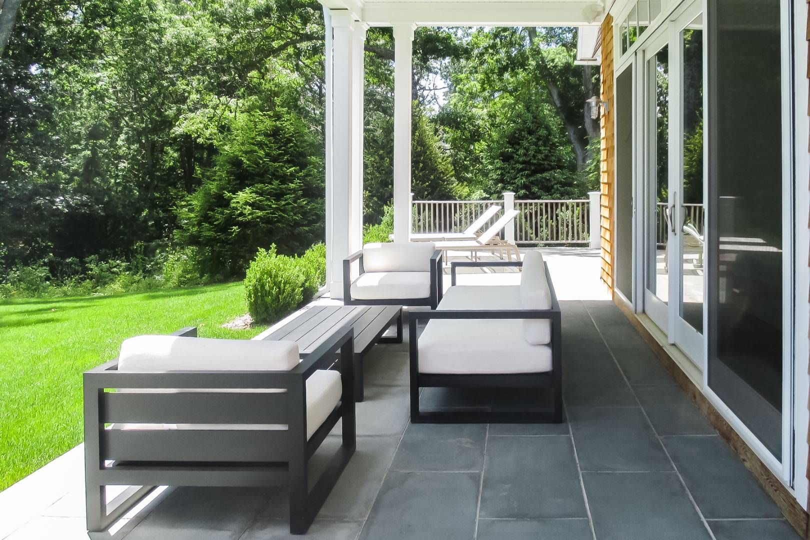 6 Shady Pth Bridgehampton, NY 11963 - Photo 19 of 20 a view of a patio with couches chairs and a yard