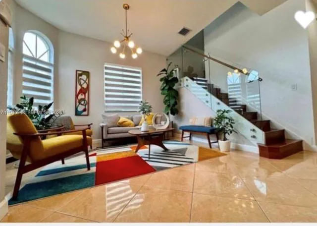 a living room filled with furniture and a chandelier