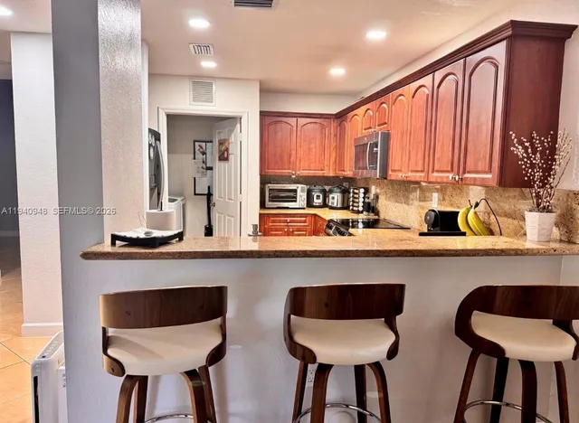 a kitchen with stainless steel appliances a sink and cabinets