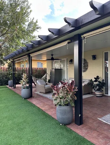 a view of a patio with chair and tables back yard