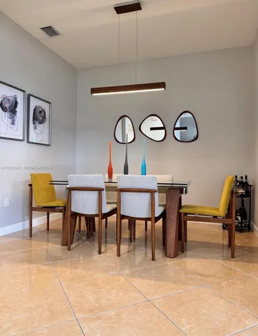 a view of a dinning table and chairs in a room
