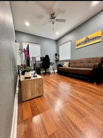 a living room with furniture and kitchen view
