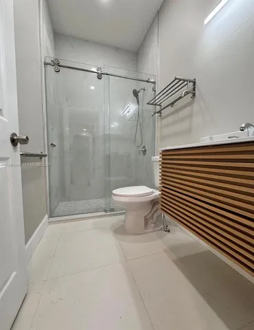 a bathroom with a shower and a toilet