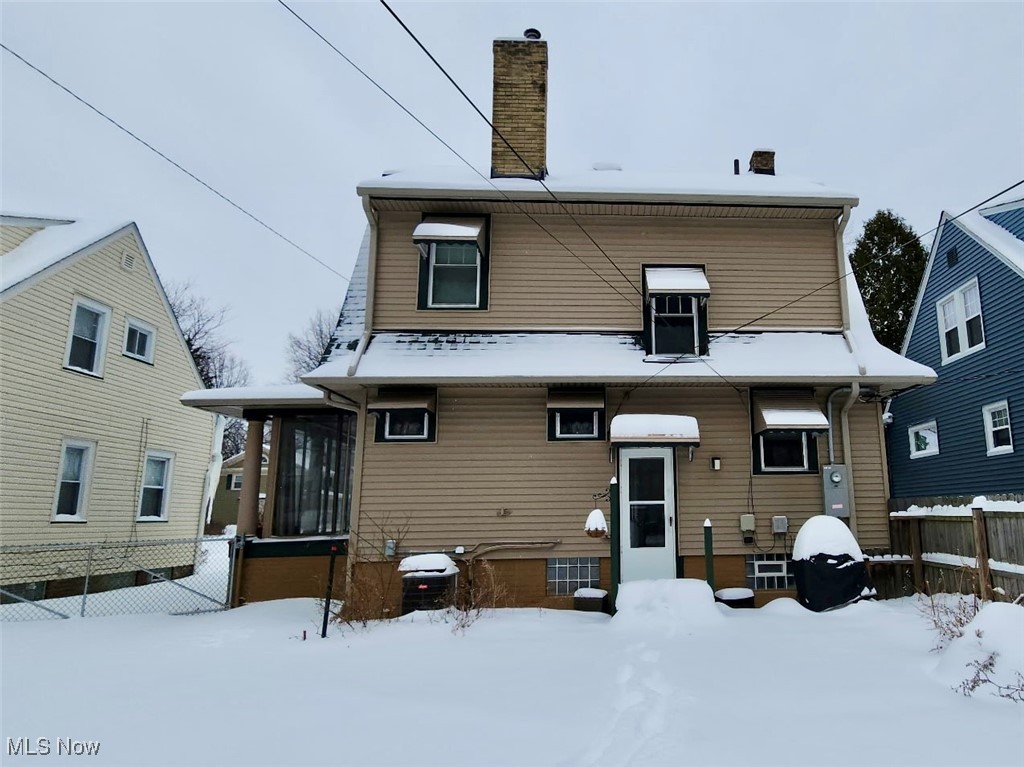 1076 Rushleigh Road Cleveland Heights, OH 44121 - Photo 23 of 27 Rear view of house featuring a sunroom and a chimney