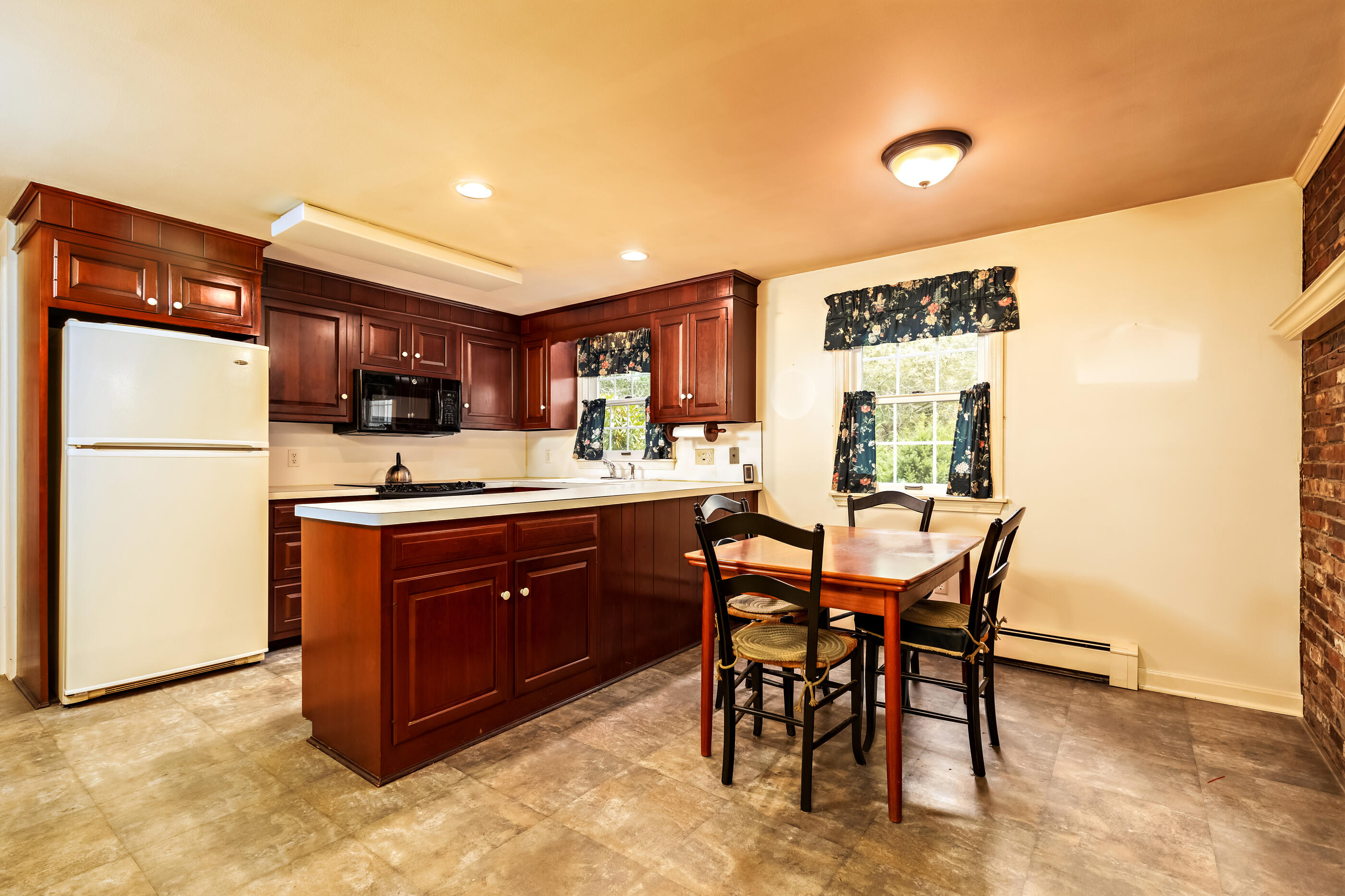 76 Goose Point Road Centerville, MA 02601 - Photo 13 of 34 a kitchen with stainless steel appliances granite countertop a sink a stove a refrigerator and a dining table with wooden cabinet