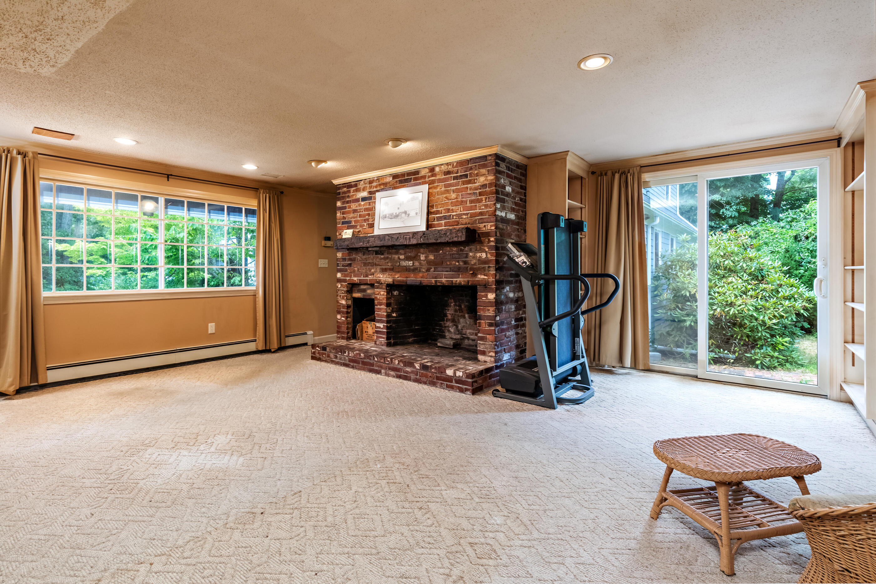 76 Goose Point Road Centerville, MA 02601 - Photo 15 of 34 a view of an empty room with windows a fireplace and a flat screen tv