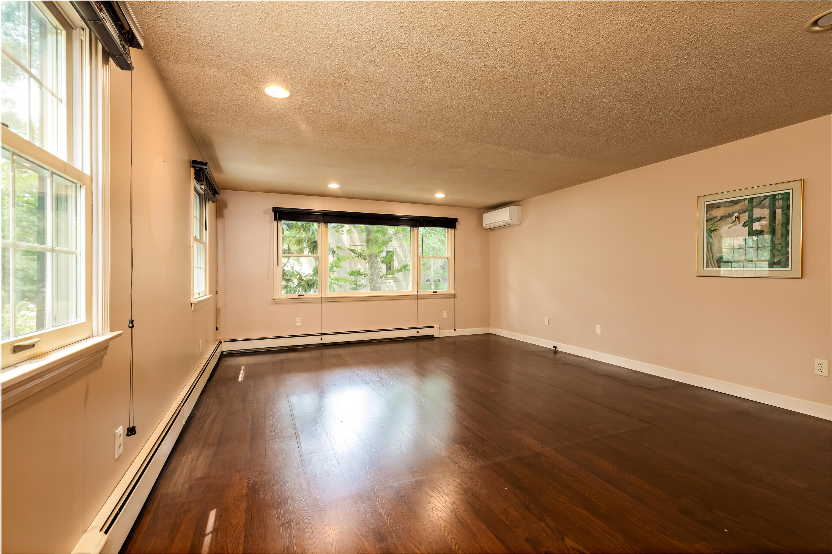 76 Goose Point Road Centerville, MA 02601 - Photo 24 of 34 an empty room with wooden floor and windows