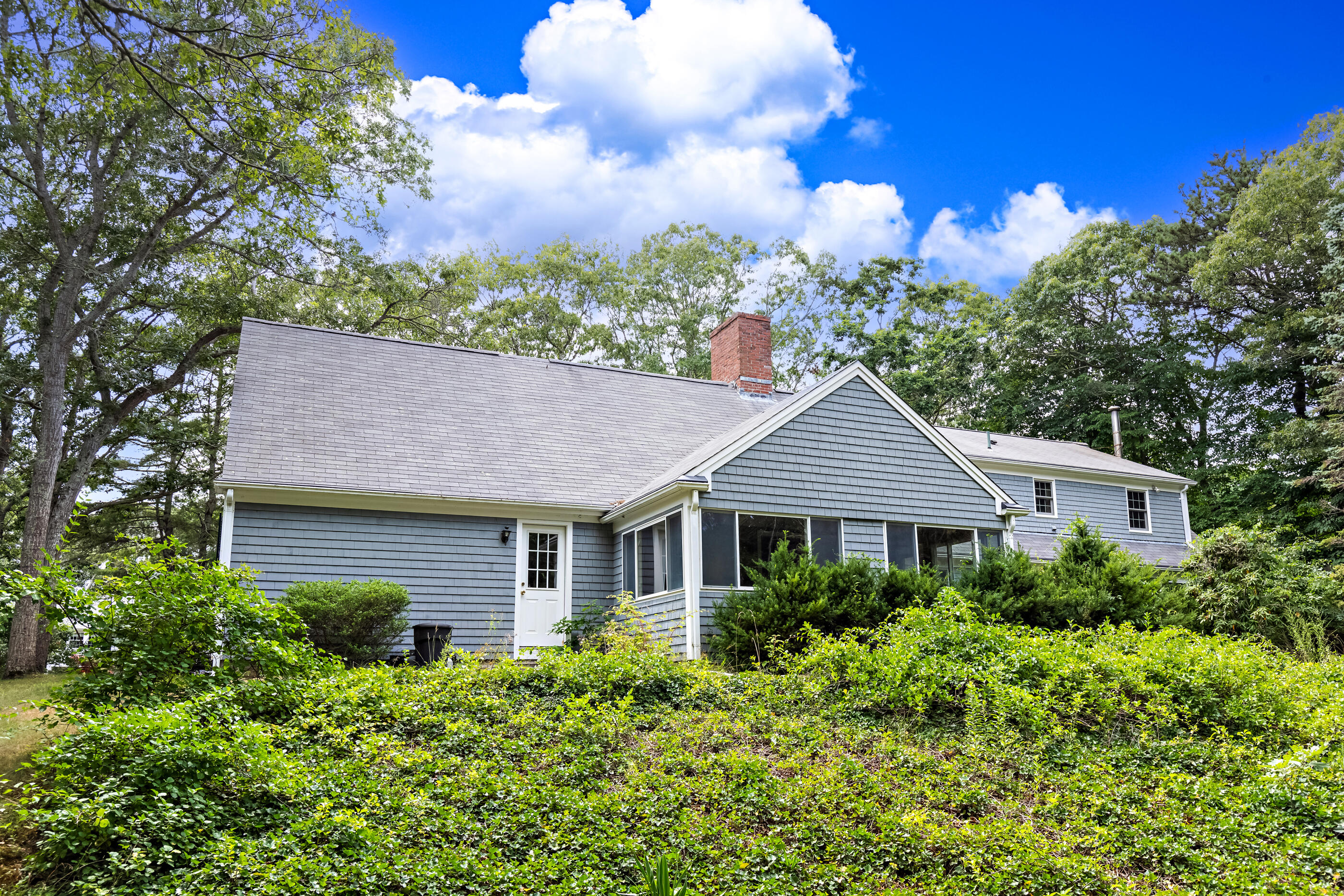 76 Goose Point Road Centerville, MA 02601 - Photo 3 of 34 a front view of a house with a yard