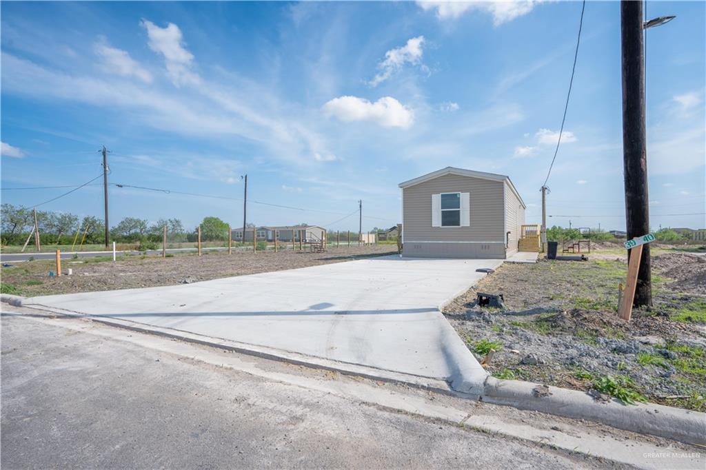 36042 Ranch Park Road San Benito, TX 78586 - Photo 3 of 25 a view of a house with a yard and potted plants