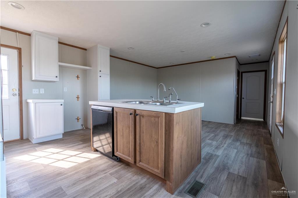 36042 Ranch Park Road San Benito, TX 78586 - Photo 7 of 25 a view of a room with wooden floor and electronic appliances