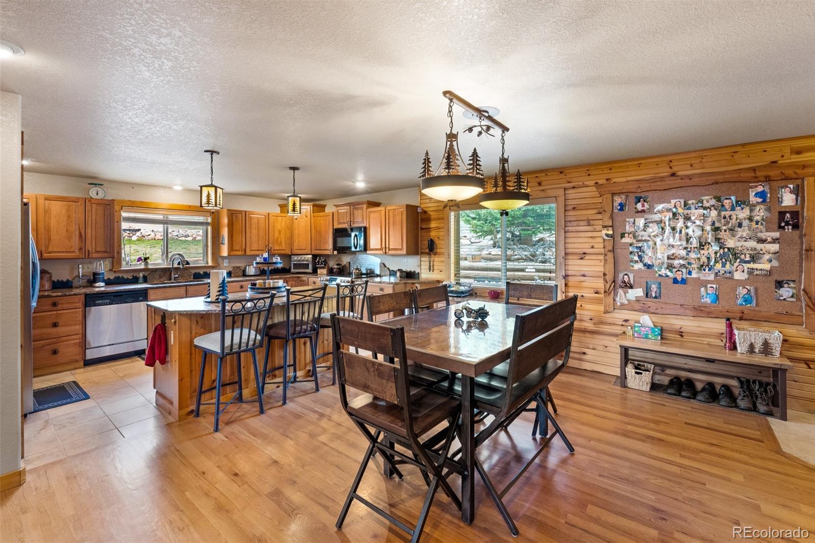 1163 Michigan Hill Road Jefferson, CO 80456 - Photo 4 of 48 a very nice looking dining room with kitchen island furniture and a large window
