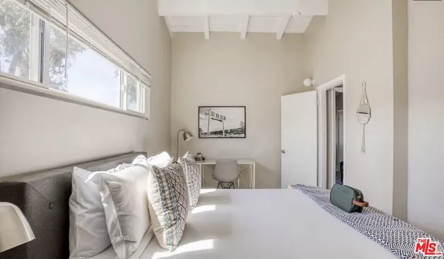 a bedroom with a bed and a window