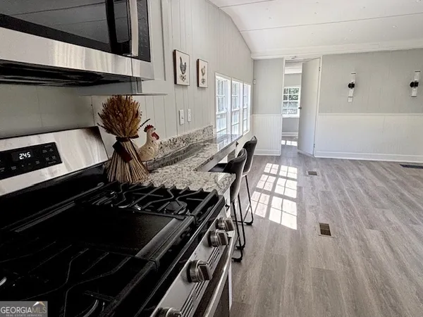 a kitchen with a stove and a microwave
