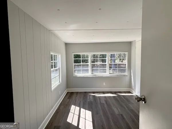 a view of a room with wooden floor and windows