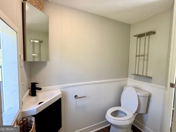 a white toilet sitting next to a bathroom sink