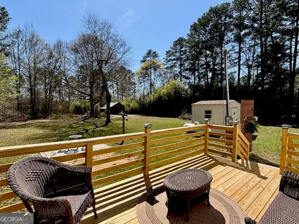 a view of table and chairs with wooden fence