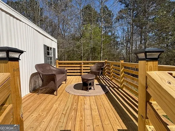a view of a roof deck with wooden floor and fence