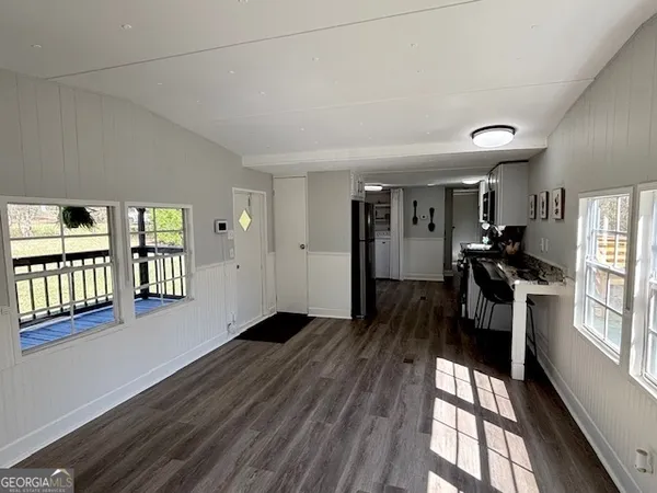 a view of a living room with hardwood floor and a window