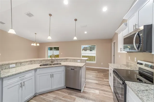 a kitchen with a sink stove and microwave