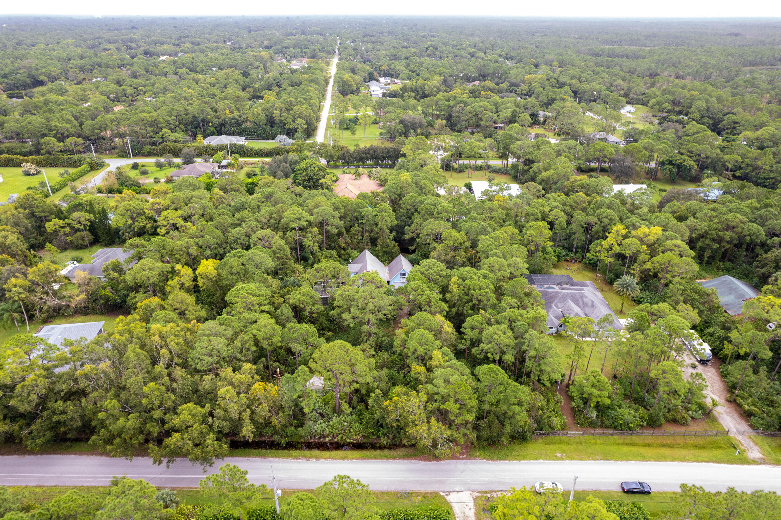 15184 Alexander Run Jupiter, FL 33478 - Photo 33 of 35 an aerial view of residential houses with outdoor space and trees
