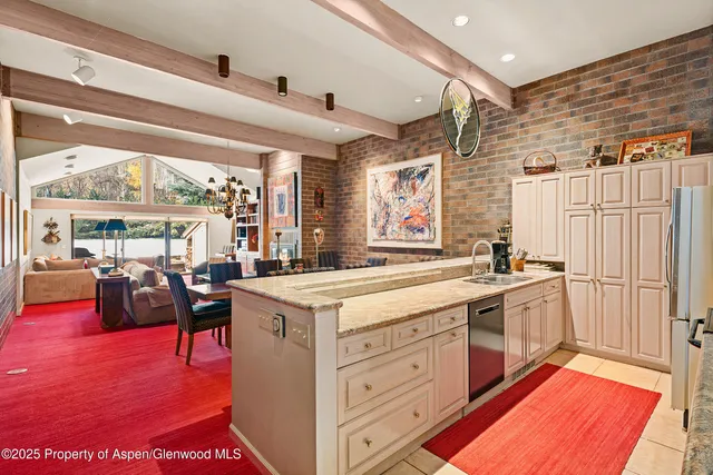 a kitchen with a stove a refrigerator and a fireplace