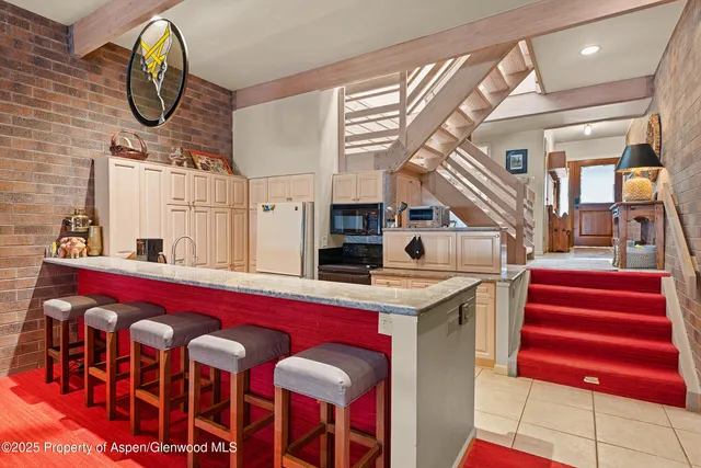 a view of a kitchen area with furniture and a fireplace
