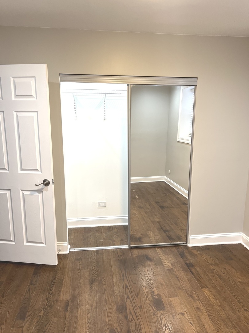 2254 West Arthur Avenue, Unit 1051A Chicago, IL 60645 - Photo 11 of 20 an empty room with wooden floor and windows