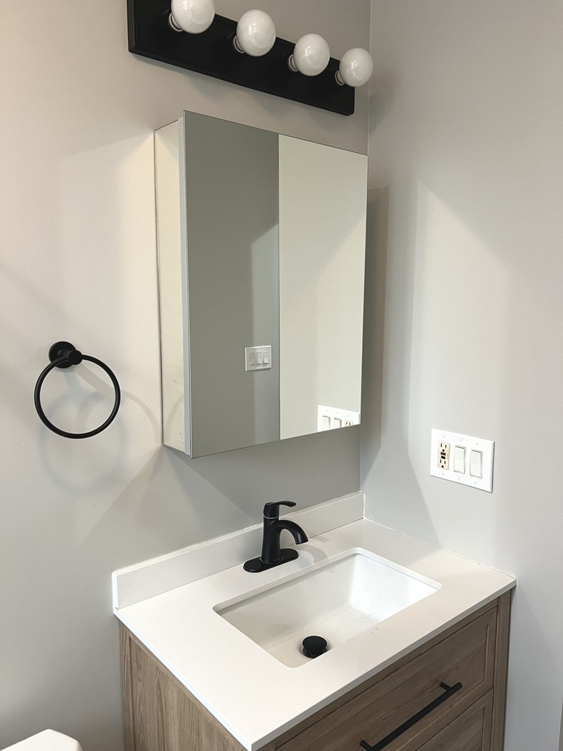 2254 West Arthur Avenue, Unit 1051A Chicago, IL 60645 - Photo 14 of 20 a bathroom with a sink and a mirror