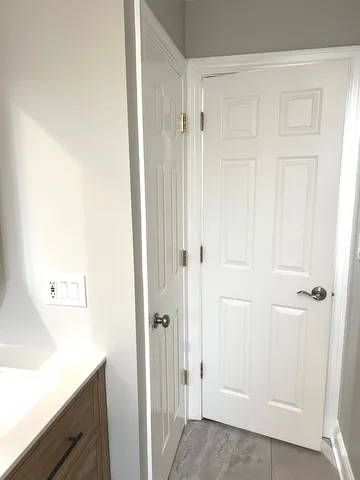 a utility room with dryer washer and a mirror