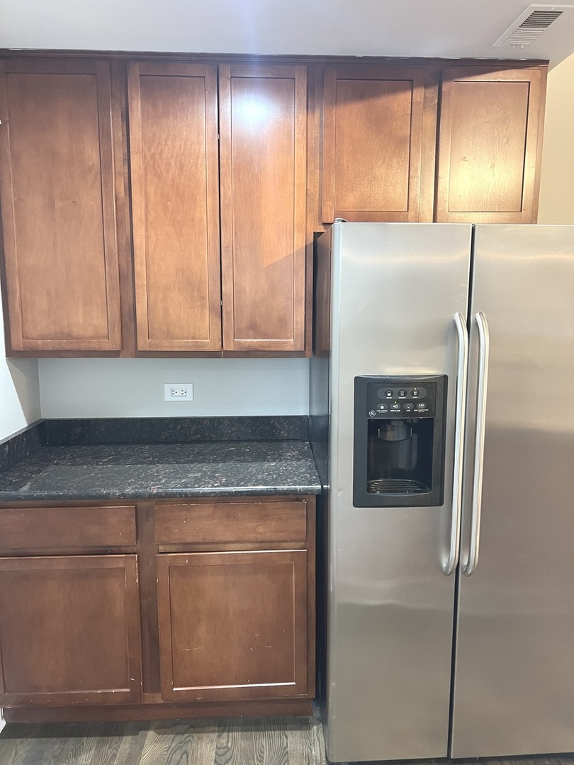 2254 West Arthur Avenue, Unit 1051A Chicago, IL 60645 - Photo 6 of 20 a kitchen with granite countertop cabinets and entrance