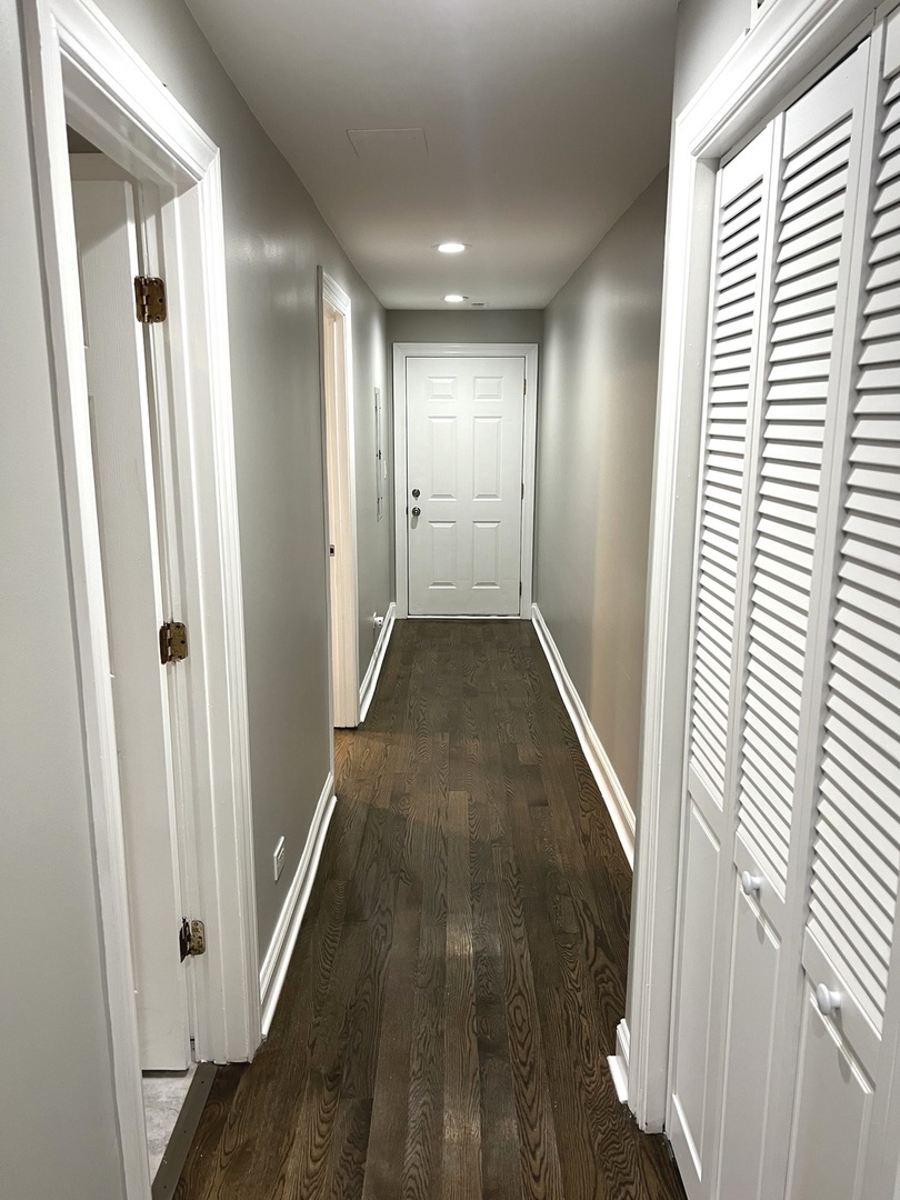 2254 West Arthur Avenue, Unit 1051A Chicago, IL 60645 - Photo 8 of 20 a view of a hallway with wooden floor and staircase