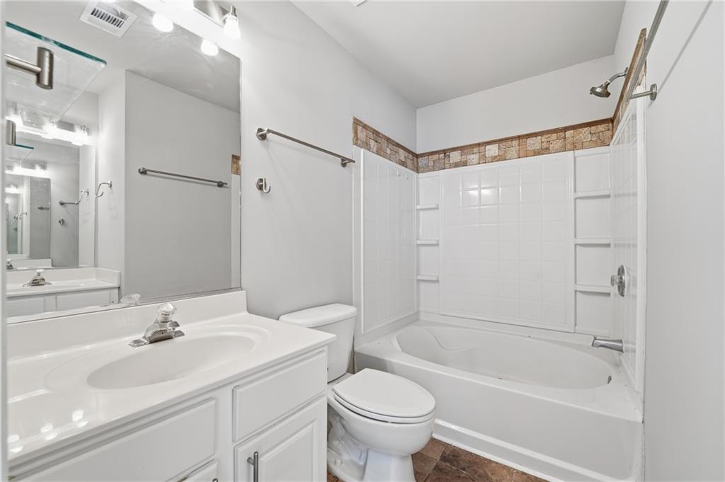3294 Mill Springs Circle Northeast Buford, GA 30519 - Photo 11 of 22 a bathroom with a sink toilet and shower
