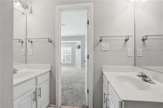 a bathroom with a sink shower and a mirror