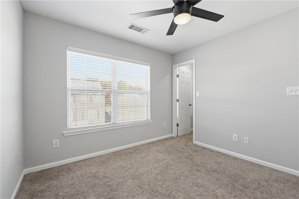 3294 Mill Springs Circle Northeast Buford, GA 30519 - Photo 13 of 22 an empty room with a window and a fan
