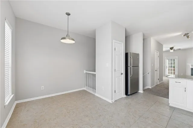 a view of a kitchen with a refrigerator and a sink