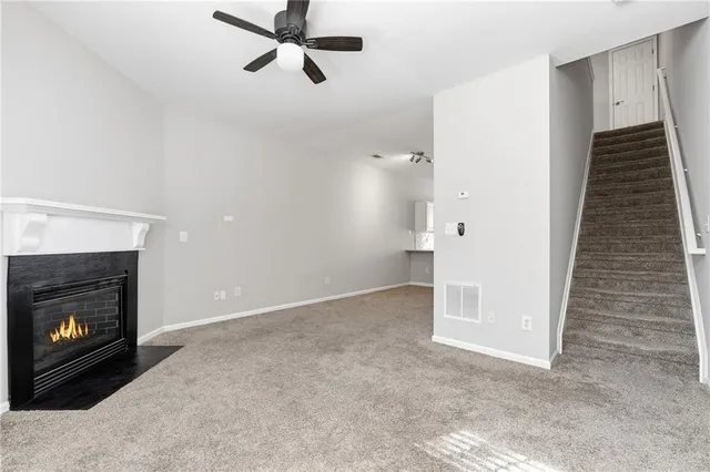 a view of a livingroom with a fireplace and window