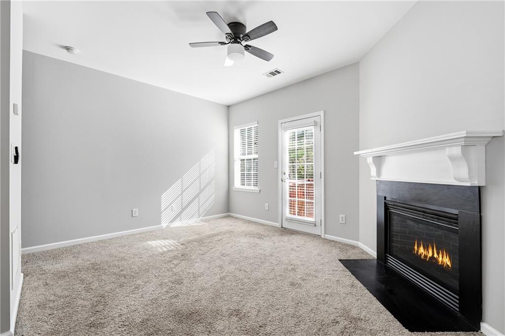 3294 Mill Springs Circle Northeast Buford, GA 30519 - Photo 8 of 22 a view of an empty room with window and fireplace