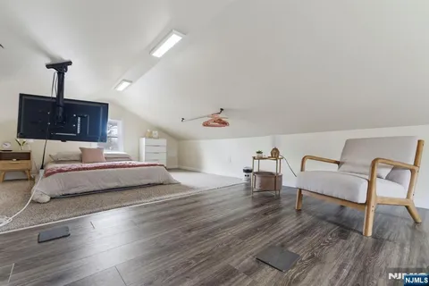 a bedroom with furniture and wooden floor