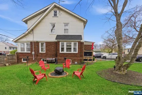 a front view of house with yard and outdoor seating