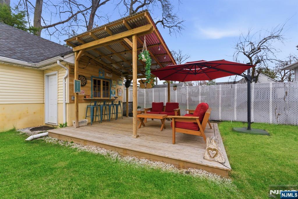 48 Rochelle Avenue Rochelle Park, NJ 07662 - Photo 24 of 30 a view of a backyard with table and chairs under an umbrella