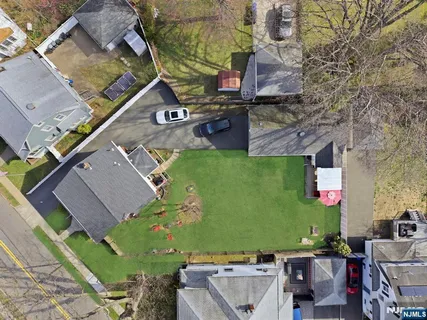 an aerial view of a house with a yard