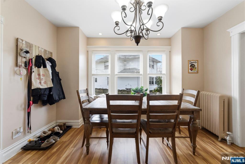 48 Rochelle Avenue Rochelle Park, NJ 07662 - Photo 7 of 30 a view of a dining room with furniture a chandelier and wooden floor