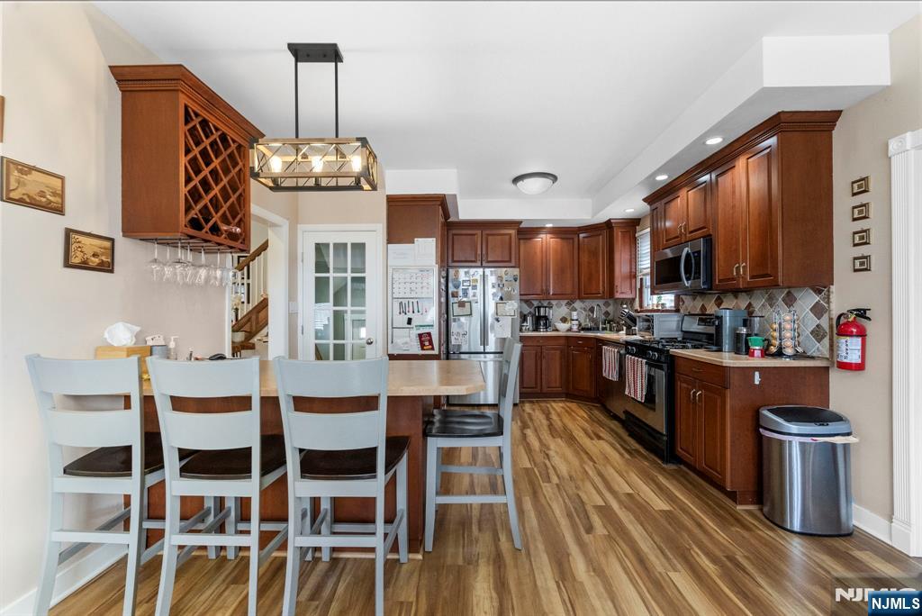48 Rochelle Avenue Rochelle Park, NJ 07662 - Photo 9 of 30 a large kitchen with a table and chairs